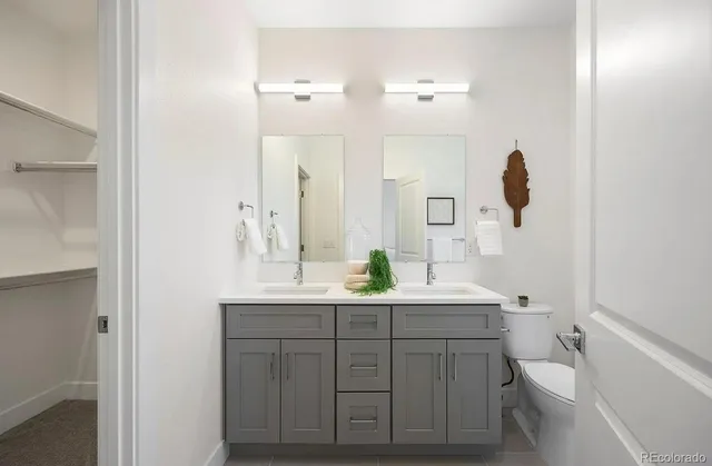 a bathroom with a double vanity sink and mirror