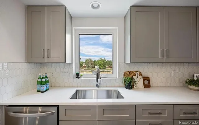 a kitchen with a sink and cabinets