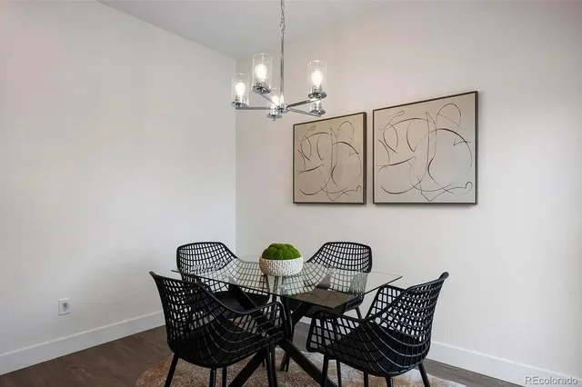 a view of a dining room with furniture and chandelier