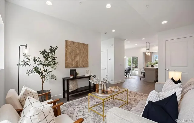 a living room with furniture and a potted plant