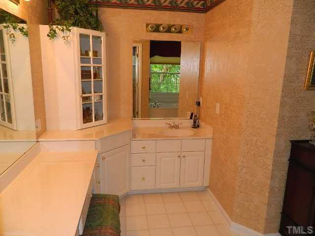 9108 Breeland Way Raleigh, NC 27613 - Photo 13 of 25 a bathroom with a sink and a mirror