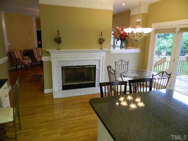 9108 Breeland Way Raleigh, NC 27613 - Photo 3 of 25 a living room with furniture wooden floor and a fireplace
