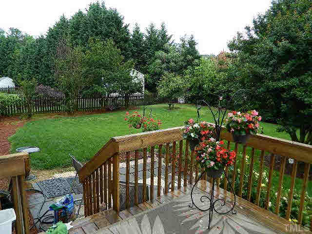 9108 Breeland Way Raleigh, NC 27613 - Photo 25 of 25 a view of a wooden deck and a garden