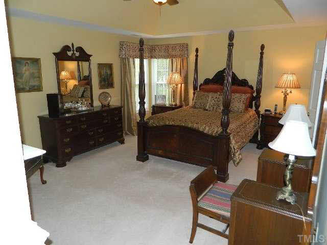 9108 Breeland Way Raleigh, NC 27613 - Photo 9 of 25 a bedroom with bed and window