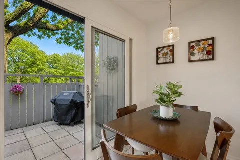 a dining room with furniture and a potted plant