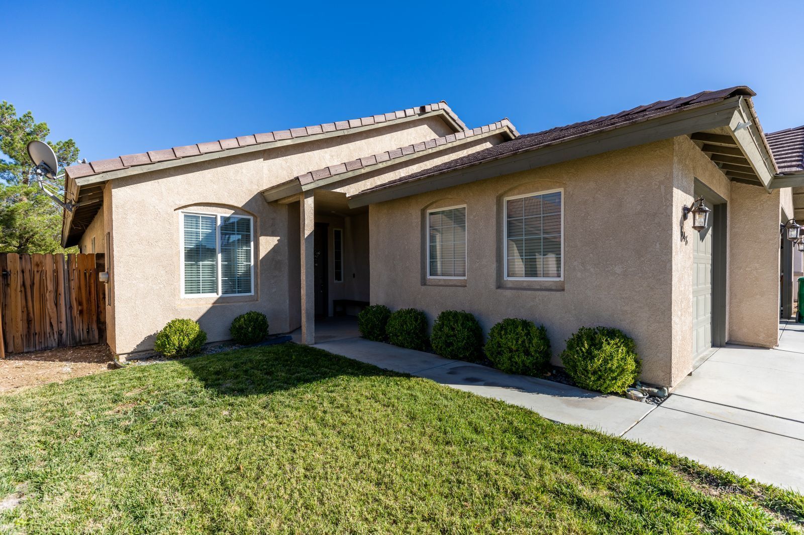 648 Pinon Court Ridgecrest, CA 93555 - Photo 3 of 35 a view of a house with wooden walls and potted plants