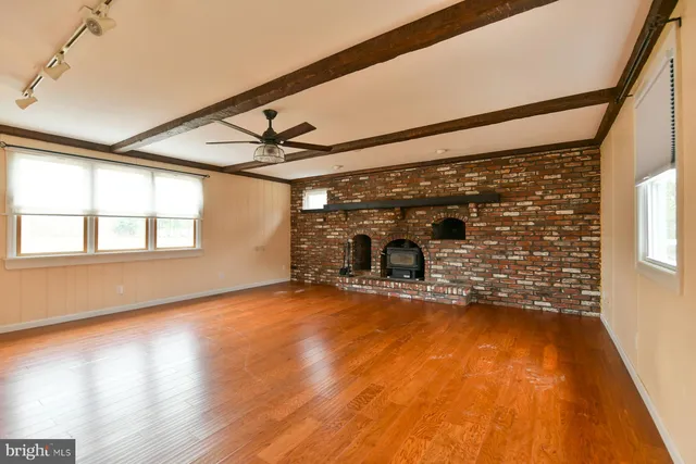 a view of a room with wooden floor
