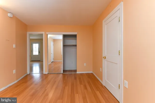 a view of hallway with wooden floor