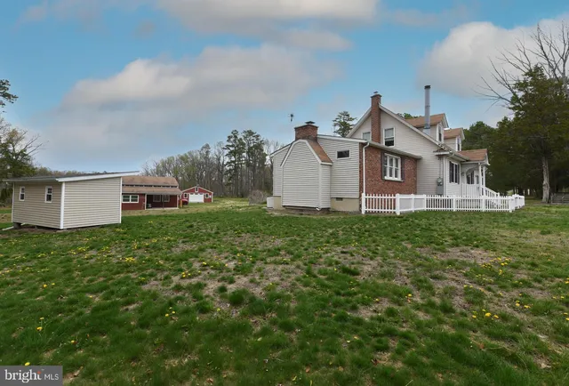 an aerial view of residential houses with yard and trees