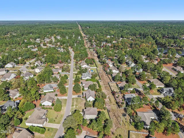 an aerial view of residential houses with city view