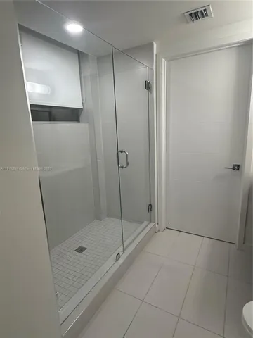 a bathroom with a shower and a toilet