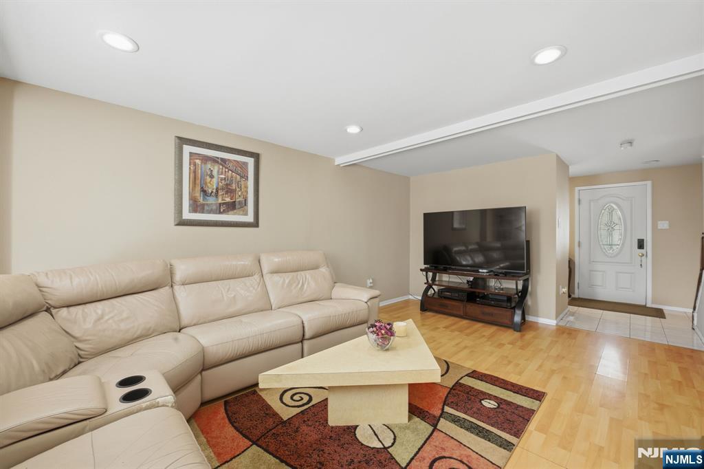 41 Woodland Road Bloomfield, NJ 07003 - Photo 13 of 27 a living room with furniture and a flat screen tv
