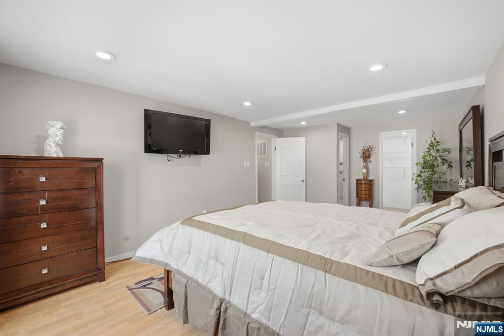41 Woodland Road Bloomfield, NJ 07003 - Photo 16 of 27 a bedroom with a bed and a flat screen tv
