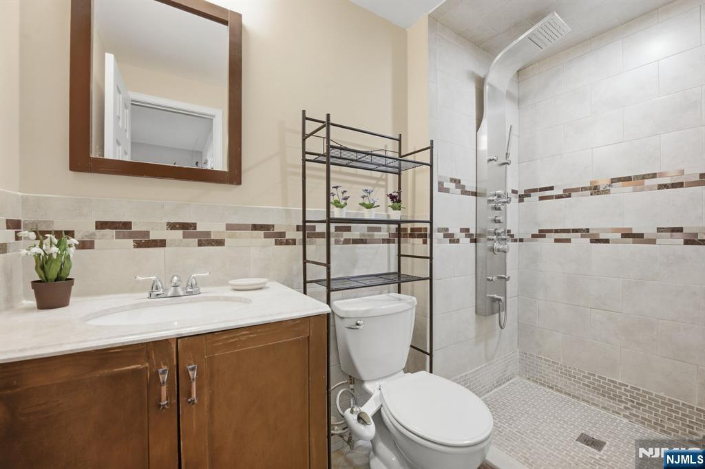 41 Woodland Road Bloomfield, NJ 07003 - Photo 17 of 27 a bathroom with a sink toilet and shower