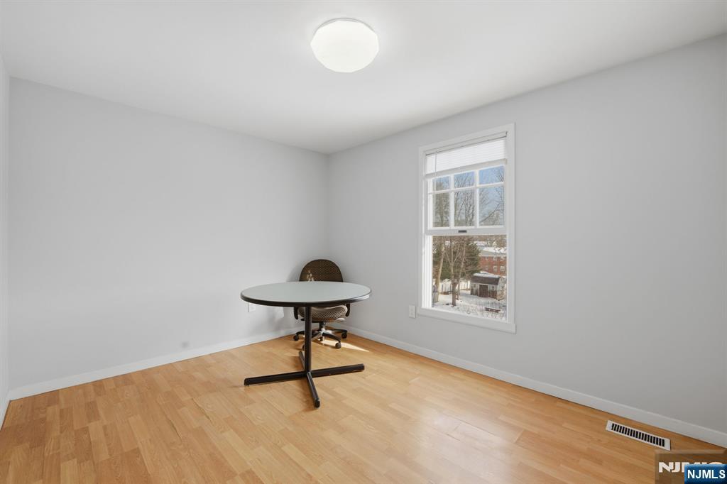 41 Woodland Road Bloomfield, NJ 07003 - Photo 19 of 27 a view of an empty room with a window and wooden floor