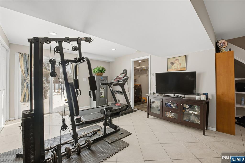 41 Woodland Road Bloomfield, NJ 07003 - Photo 23 of 27 a view of a livingroom with furniture and a flat screen tv