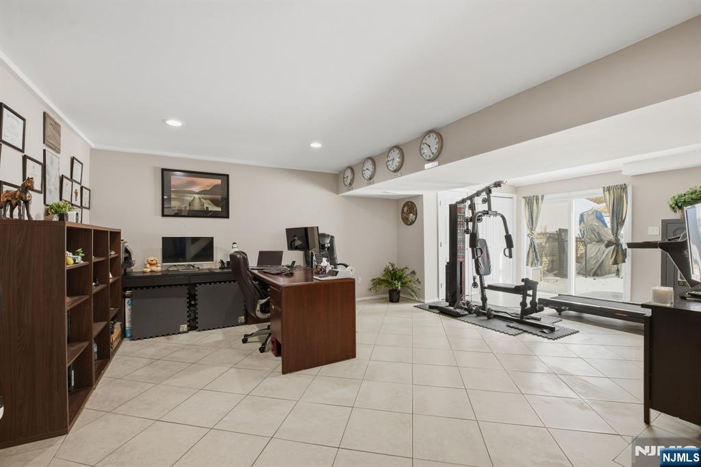 41 Woodland Road Bloomfield, NJ 07003 - Photo 25 of 27 a view of a livingroom with workspace and gym equipment