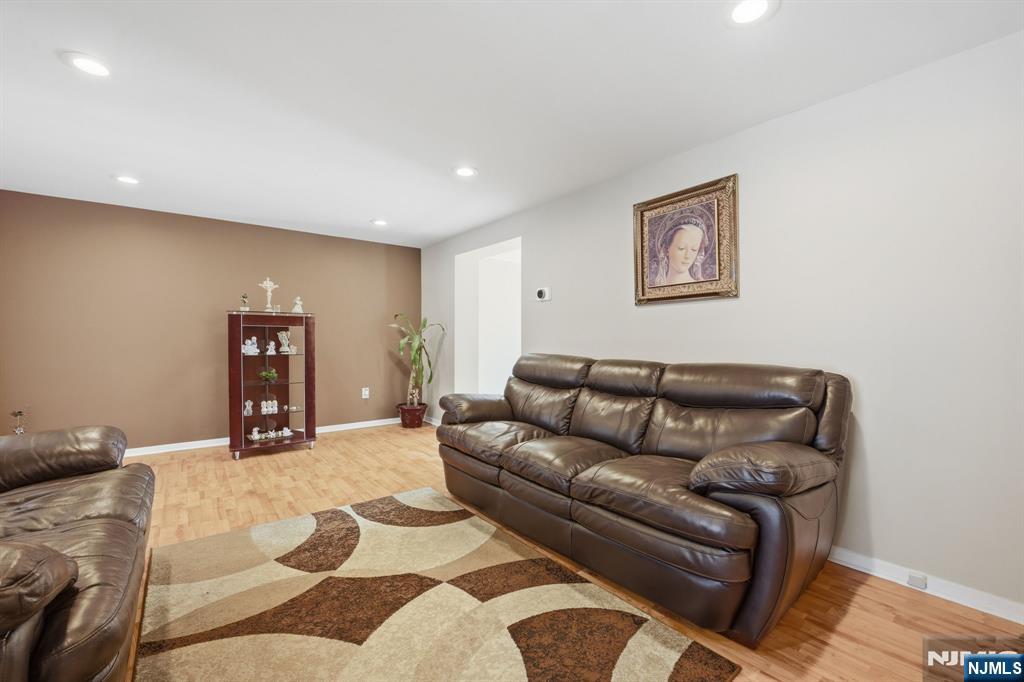 41 Woodland Road Bloomfield, NJ 07003 - Photo 4 of 27 a living room with furniture and painting on the wall