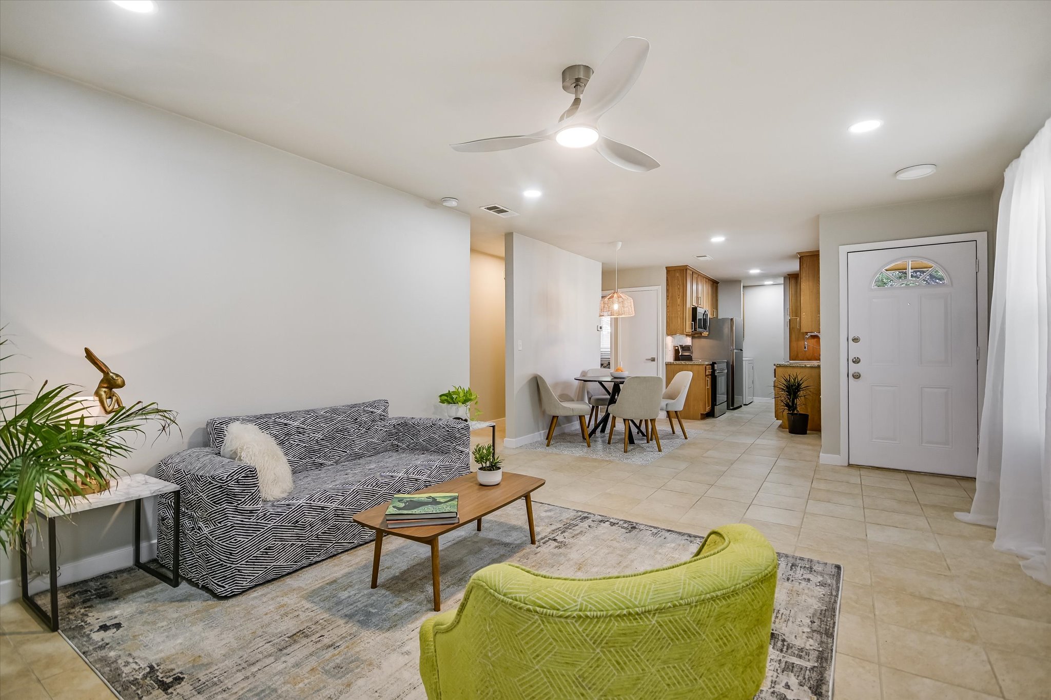 4902 Duval Road, Unit H1 Austin, TX 78727 - Photo 5 of 20 An inviting open-concept layout connects the well-lit living area to a casual dining space and kitchen.