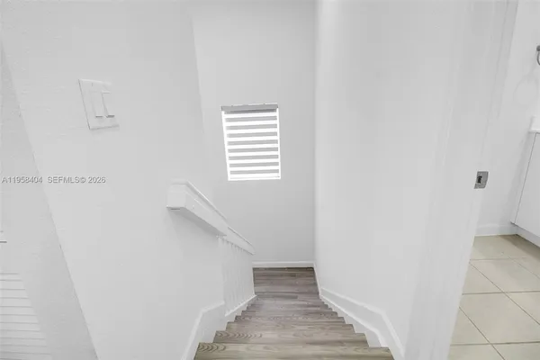 a view of a hallway with stairs