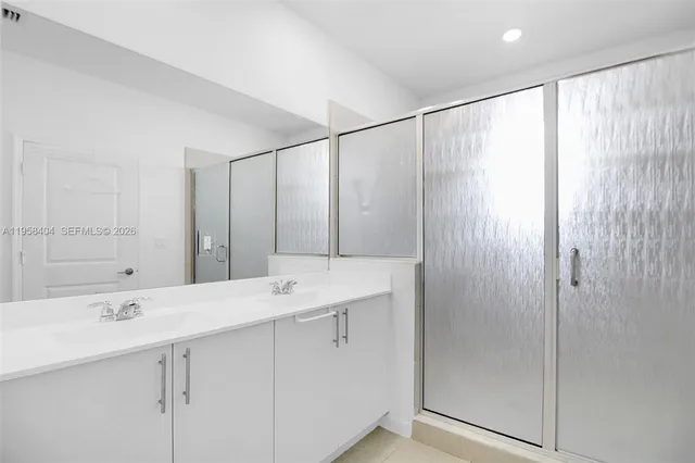 a bathroom with a double vanity sink and a mirror