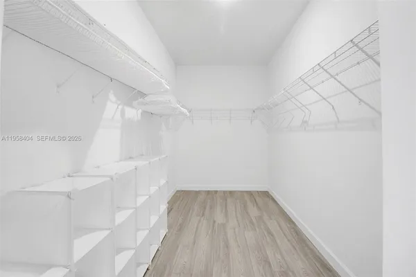 a view of a room with wooden floor