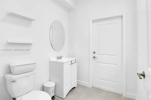 a white toilet sitting next to a bathroom sink