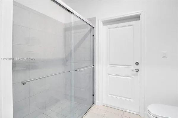 a bathroom that has a glass shower door