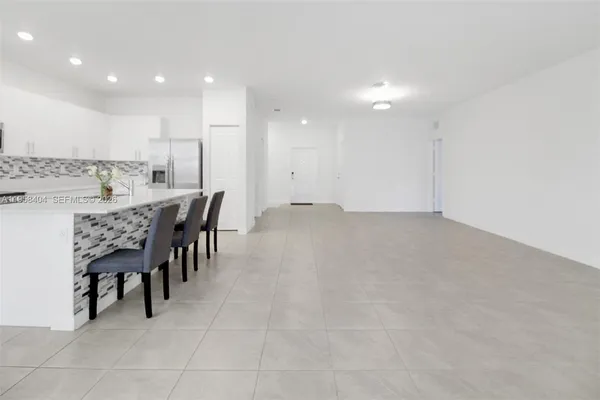 a large kitchen with a table and chairs