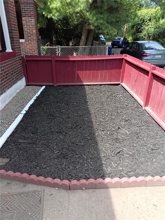 649 Singer Place Pittsburgh, PA 15221 - Photo 2 of 20 a view of a back yard with a wooden fence