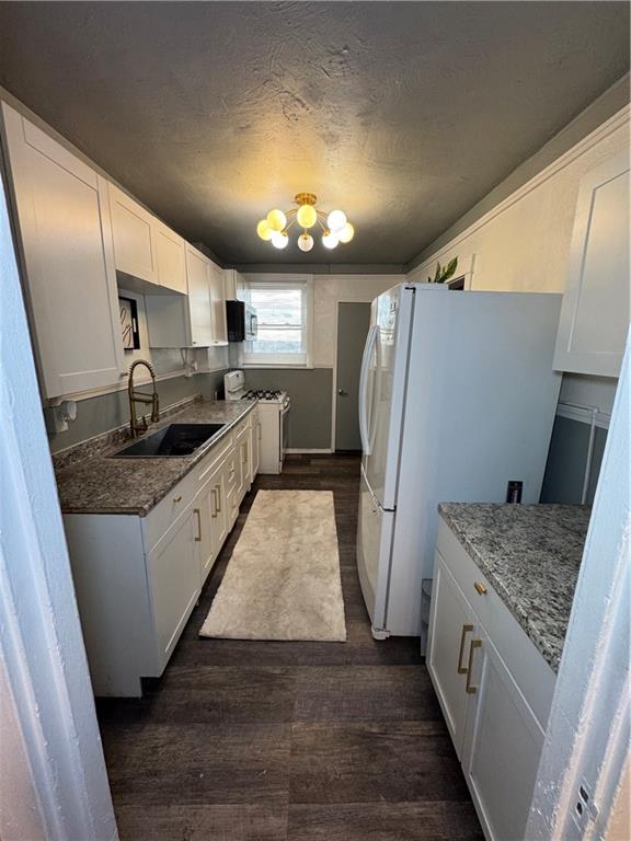 649 Singer Place Pittsburgh, PA 15221 - Photo 6 of 20 a kitchen with stainless steel appliances granite countertop a sink stove and refrigerator