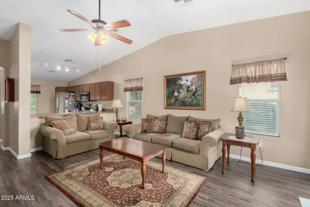 a living room with furniture and a wooden floor