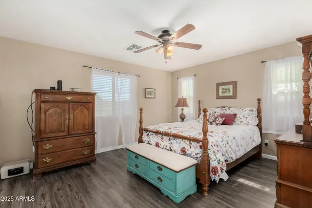 a bedroom with a bed and wooden floor