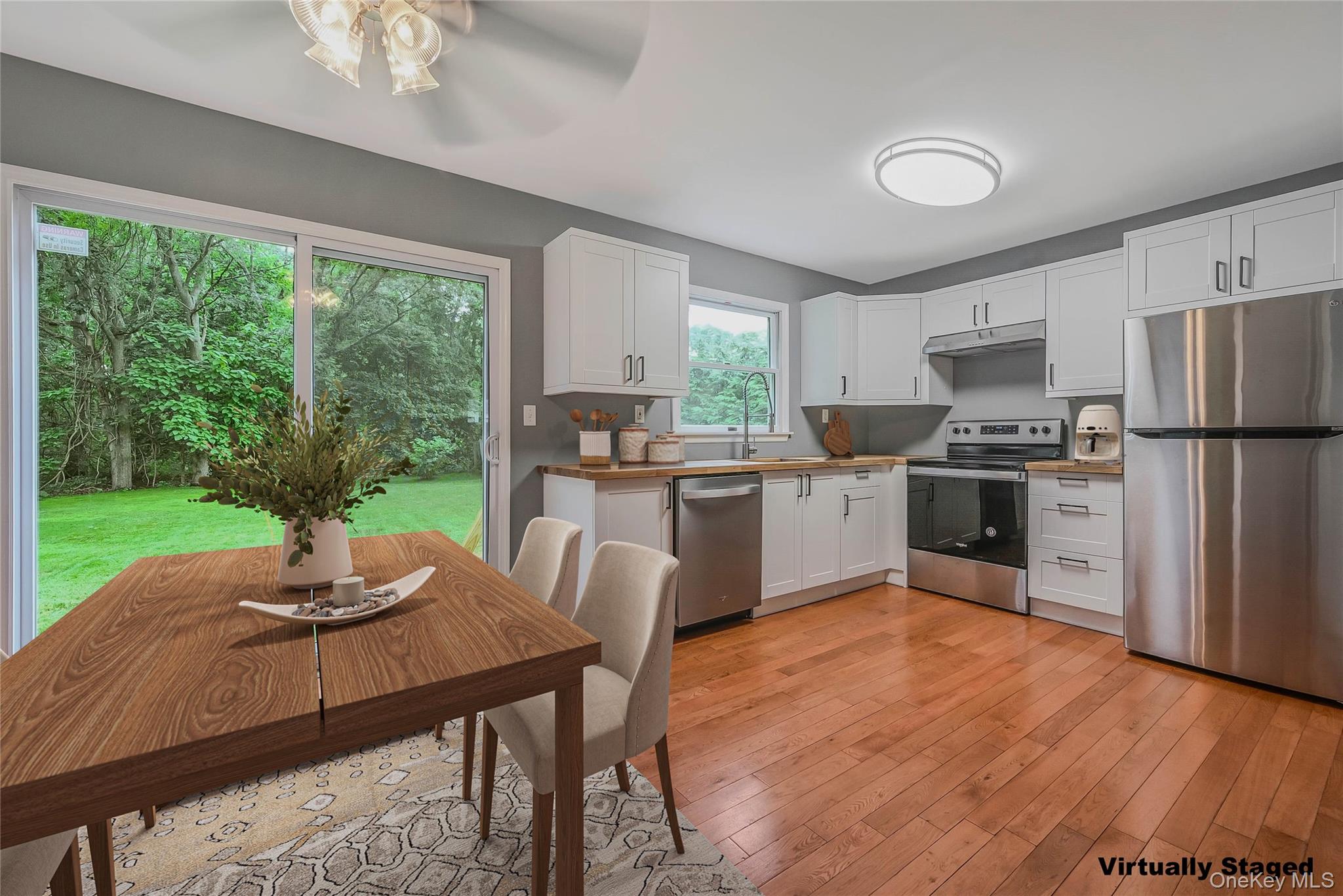a kitchen with a table chairs refrigerator and microwave