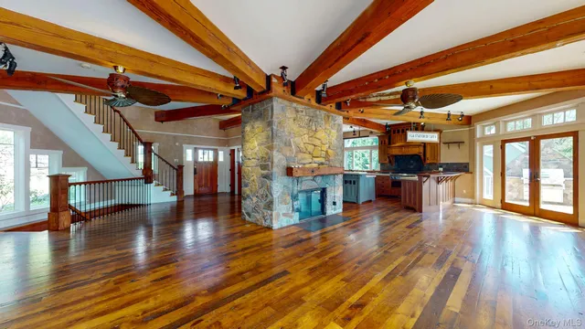 a view of an entryway with wooden floor and door