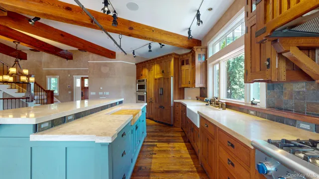 a kitchen with a sink stove and cabinets