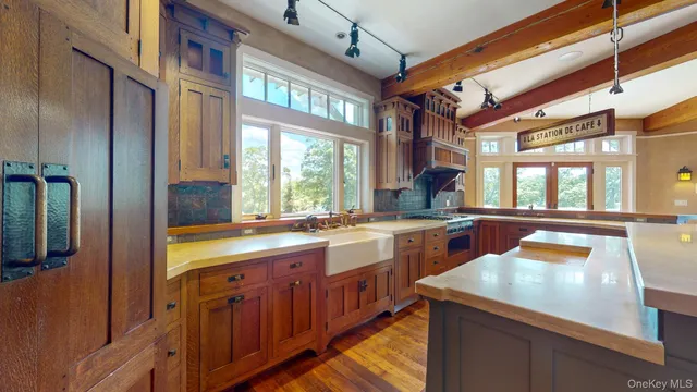 a kitchen that has a sink and a stove in it