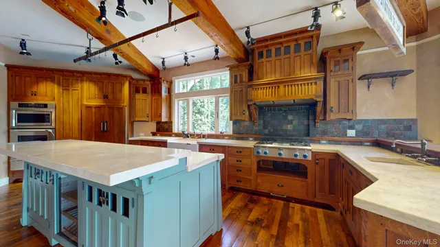 a open kitchen with stainless steel appliances granite countertop a stove and a refrigerator