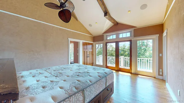 a living room with a bed and paintings on the wall