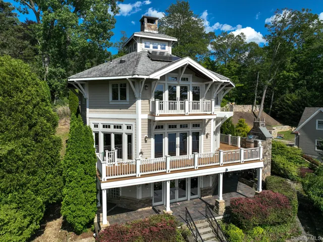 a view of a balcony with wooden fence and floor