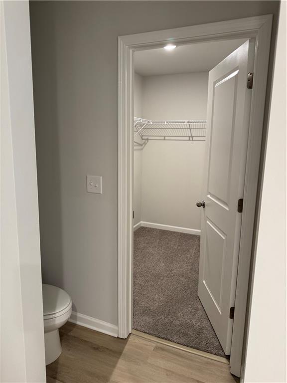 11067 Suria Drive Covington, GA 30014 - Photo 18 of 22 a bathroom with a granite countertop toilet and a shower