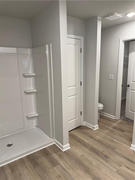 11067 Suria Drive Covington, GA 30014 - Photo 20 of 22 a view of empty room with wooden floor and bathroom