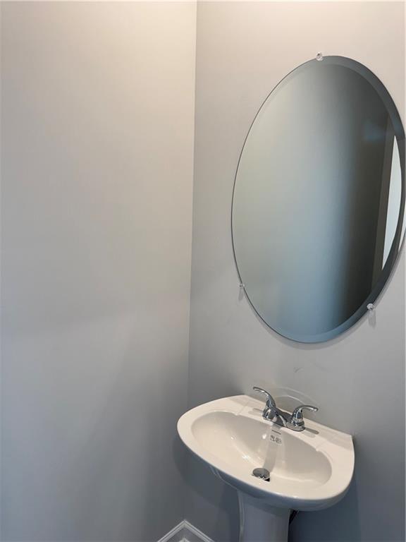 11067 Suria Drive Covington, GA 30014 - Photo 22 of 22 a bathroom with a sink and a mirror