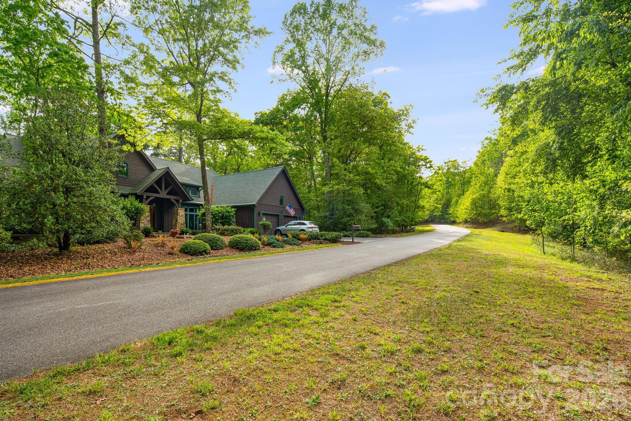 0 Newcastle Road, Unit 52 Brevard, NC 28712 - Photo 11 of 29 a front view of a house with a yard and garage