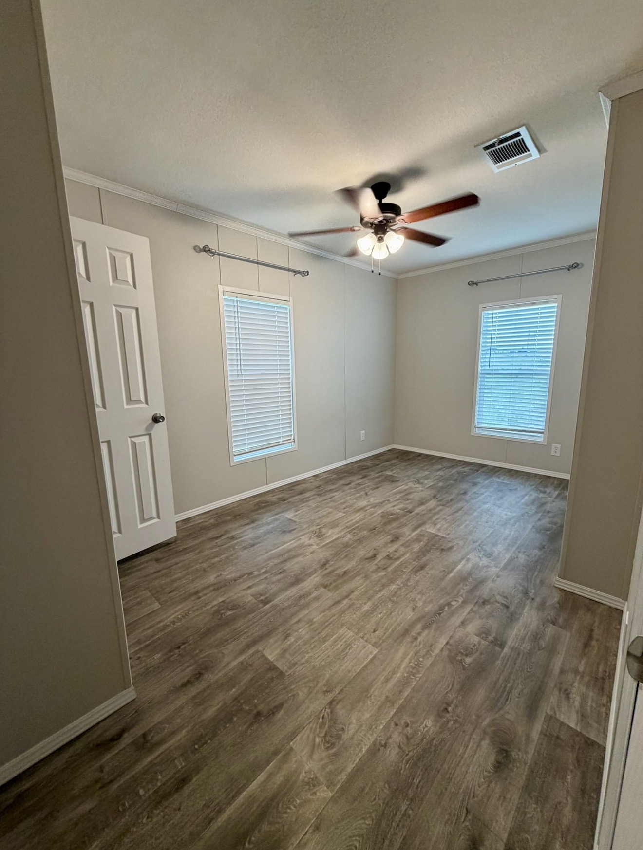126 Castellana Way Elgin, TX 78621 - Photo 14 of 19 an empty room with windows and fan