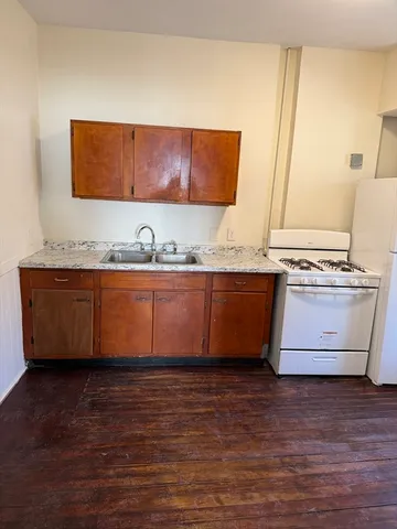 a view of kitchen with stainless steel appliances granite countertop a sink and a stove