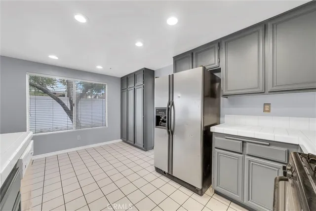a kitchen with stainless steel appliances a refrigerator sink and cabinets