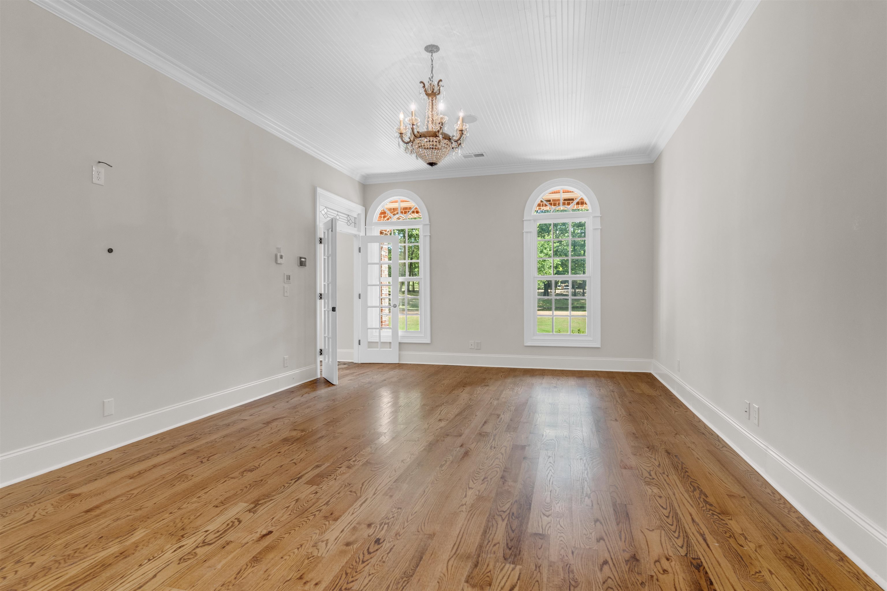 815 Dent Road Eads, TN 38028 - Photo 22 of 40 Unfurnished room featuring ornamental molding, wood finished floors, and a chandelier