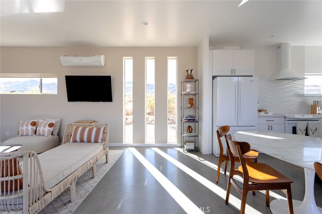 7802 Quail Springs Road Joshua Tree, CA 92252 - Photo 12 of 46 a living room with furniture and a flat screen tv