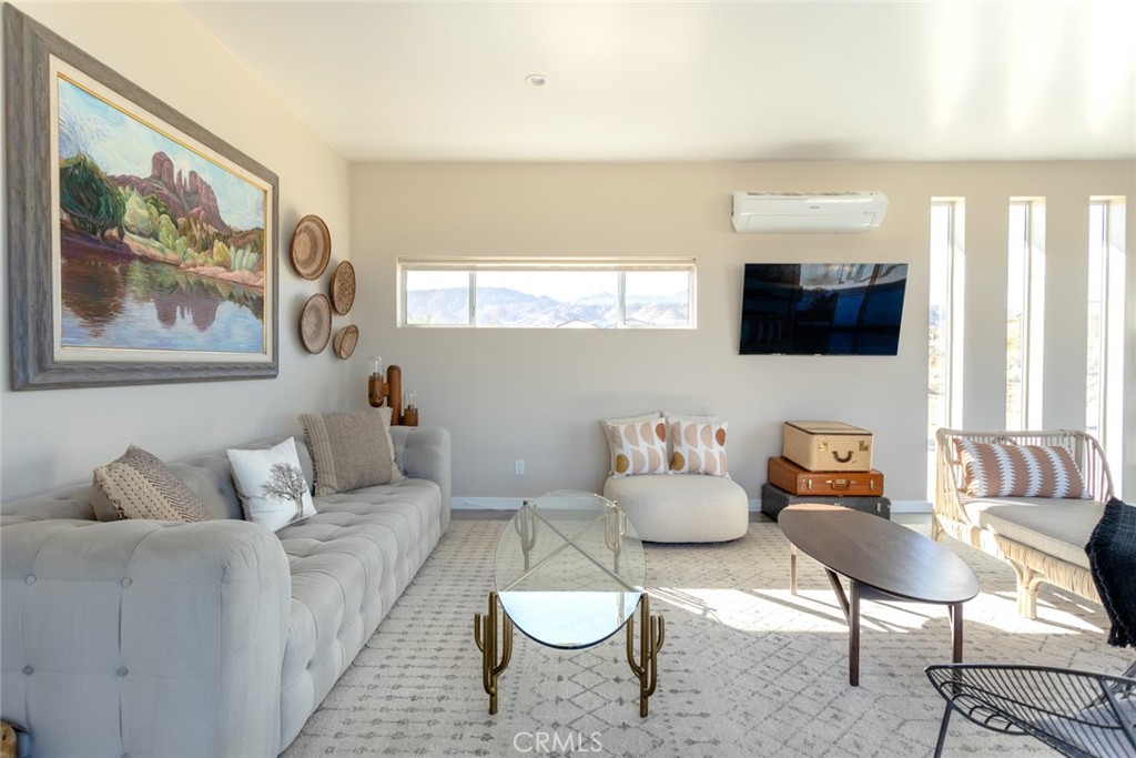 7802 Quail Springs Road Joshua Tree, CA 92252 - Photo 13 of 46 a living room with furniture and a flat screen tv